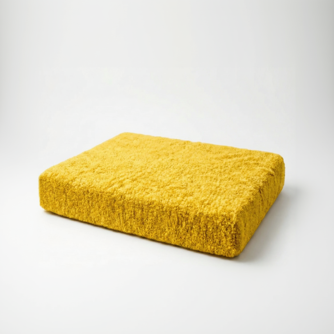 Yellow textured cushion on a white background